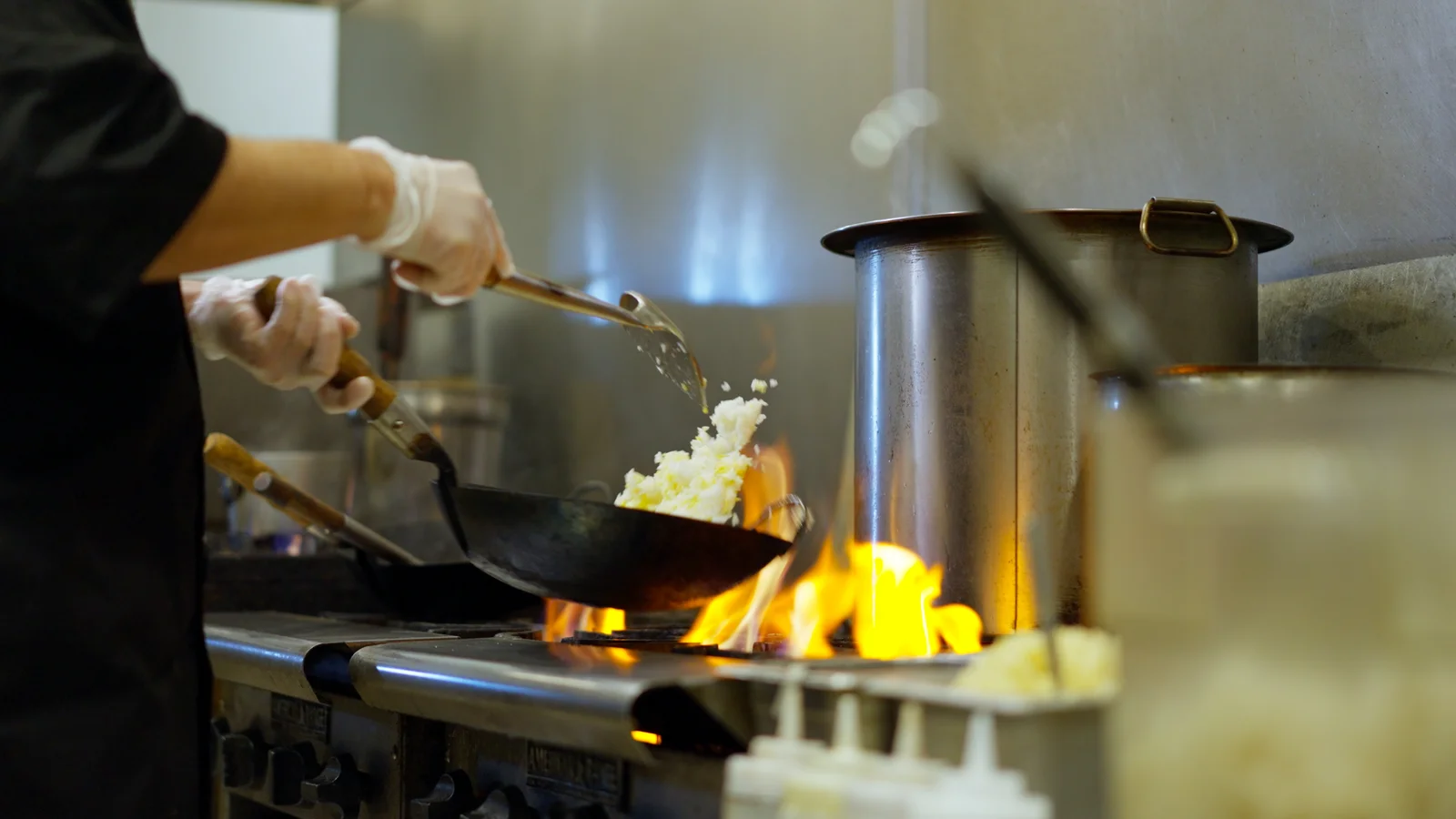 Wok over open flame in the Leela Thai kitchen