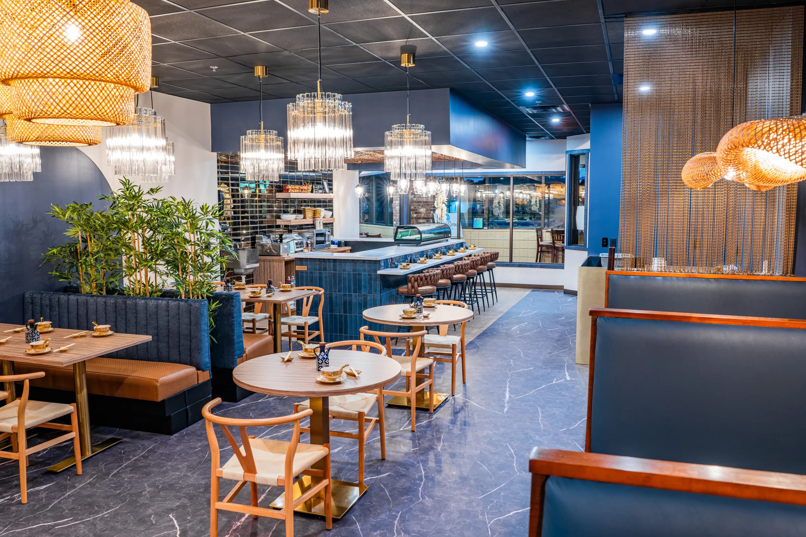 UMI's dining room and sushi bar: navy booths, marble, and glass chandeliers